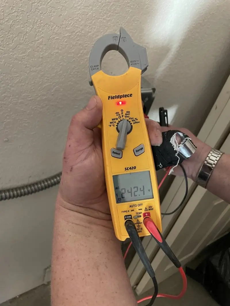 Voltage testing with clamp meter during Electrical Installation Services in Lee